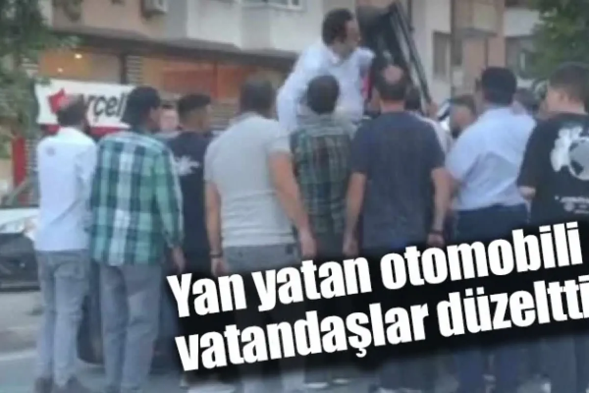 Yan yatan otomobili vatandaşlar düzeltti