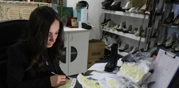 Komşuya ayakkabı giydiriyor